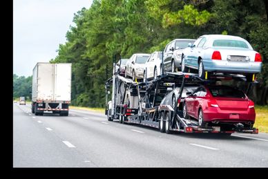 Car carrier truck transporting multiple vehicles on a highway.
