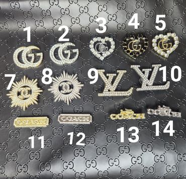 Collection of 14 luxury brand logo brooches on a Gucci background.