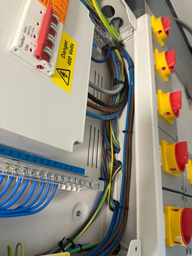 Close-up of an electrical panel with organized wiring and safety switches.