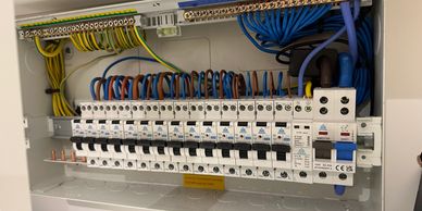 Electrical breaker panel with organized wiring and circuit breakers.