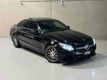 Black Mercedes-Benz sedan parked indoors with sleek design.