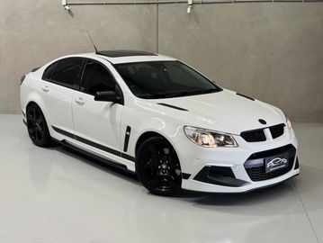 White sports sedan with black accents and tinted windows.