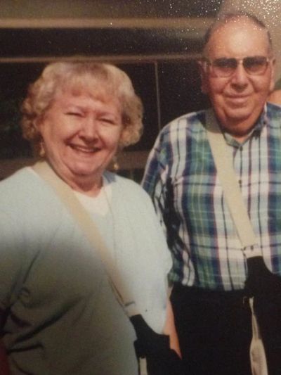 Smiling elderly couple posing together.