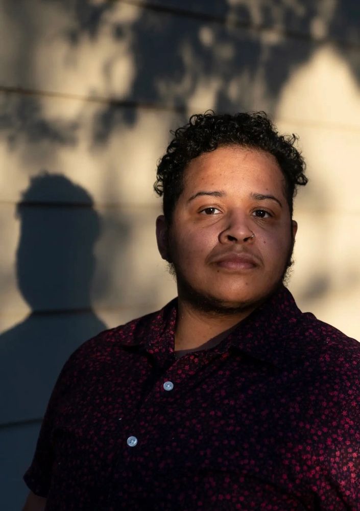 Jaden in a pink patterned shirt with a shadow behind them. 
