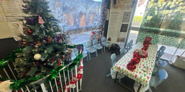A decorated Christmas tree and a festive table set for holiday celebration.