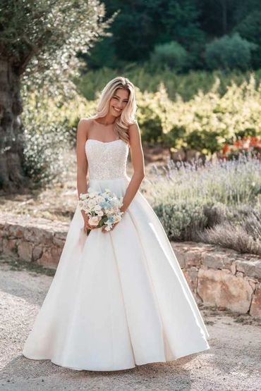 Mikado ballgown is artfully draped and paired with a sparkling beaded strapless bodice
by Allure Bri