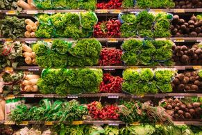 Shelves of vegetables, notably squash, radishes, potatoes, and lettuce.