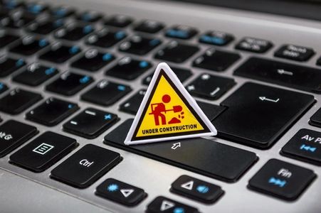 "Under Construction" sign on a laptop keyboard
