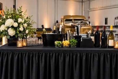 Elegant drink station with wine, champagne, and garnishes.