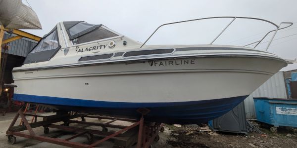 White Fairline boat named Alacrity on a trailer.