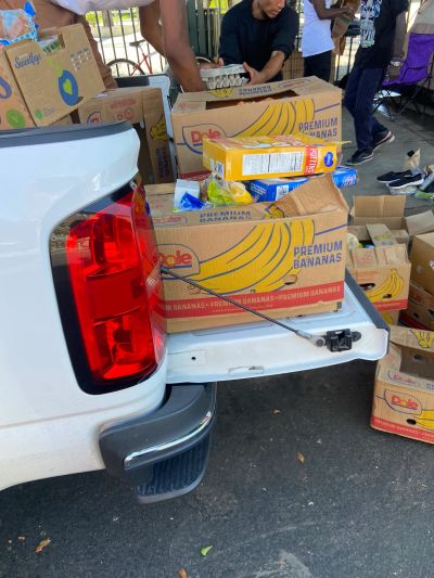 Boxes of groceries being unloaded from a truck.