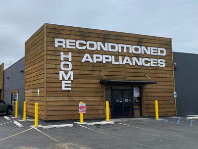 Outside of a used appliances store with the words reconditioned home appliances on the front.