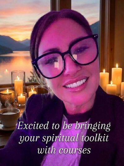 Woman smiling in glasses with candles and sunset behind, promoting spiritual courses.