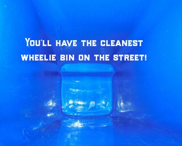 Inside view of a clean blue wheelie bin with a positive message.