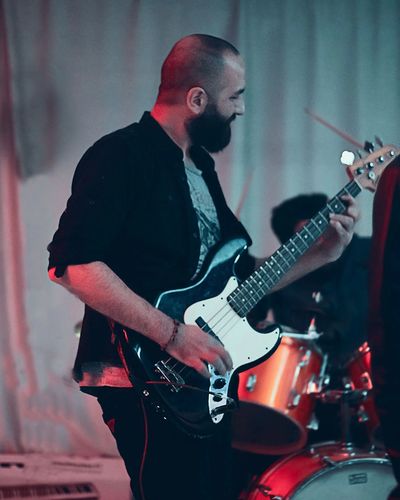 Bashar Haroun playing bass guitar in Syria as part of U-Ground music center and Music House events