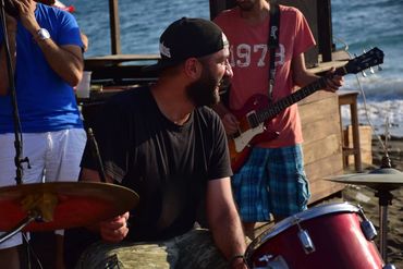 Bashar Haroun playing drums at a beach in Dubai, UAE
