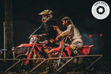 Two motocross riders preparing to race.