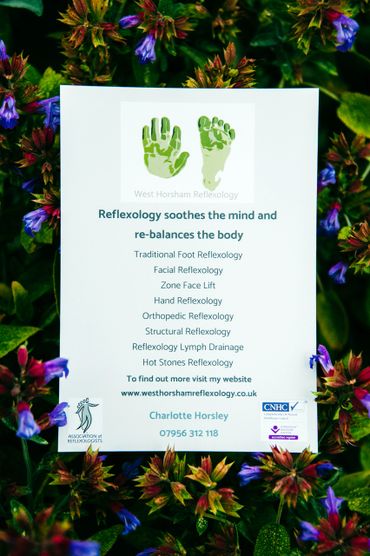 West Horsham reflexology leaflet lying in bed of blue flowers