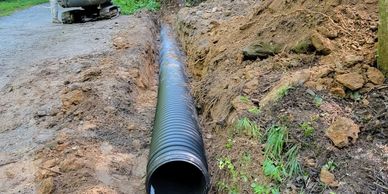 Drainage culvert installed, ready to cover.