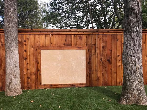 Cedar Side by Side fence with top cap, double trim and a custom chalk board.