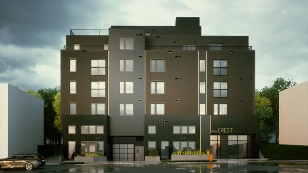 Modern apartment building named "the CREST" with dark exterior and multiple windows.