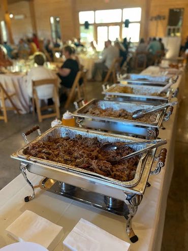 Buffet trays filled with food at a gathering or event.