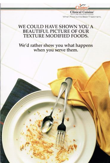 Empty plate with remnants of texture modified food and utensils.