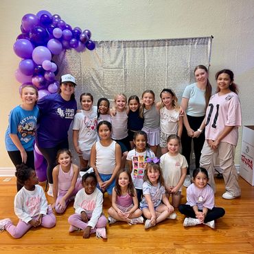 Girls by balloon backdrop