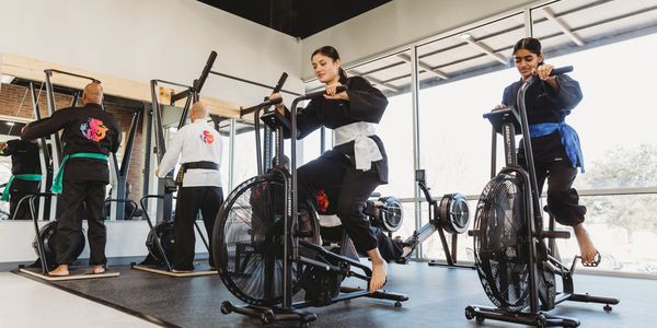 Martial arts students training in the Kung Fu Academy fitness center to enhance strength and conditi