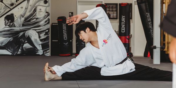 Kung Fu Academy student stretching to improve flexibility and mobility for martial arts training.