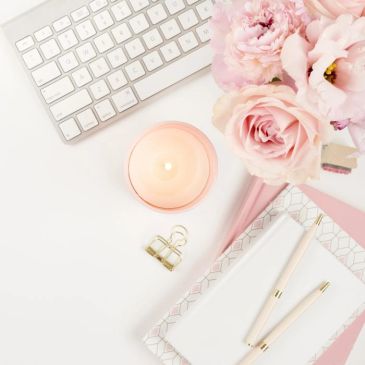 Elegant workspace with flowers and candle.