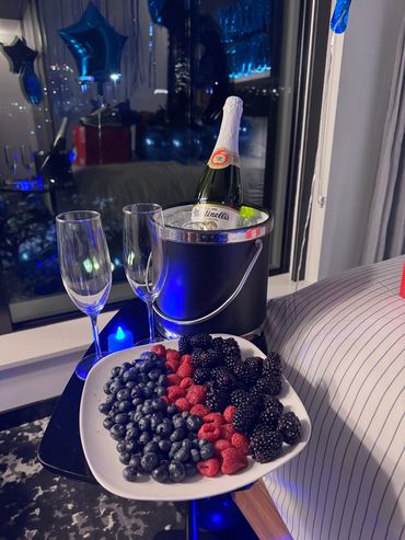 champagne on ice with berries in a decorated room hotel room in the city of boston