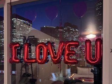 i love you balloons on a window in a hotel room in boston