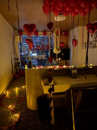 red heart balloons decorating a hotel room in the city of boston