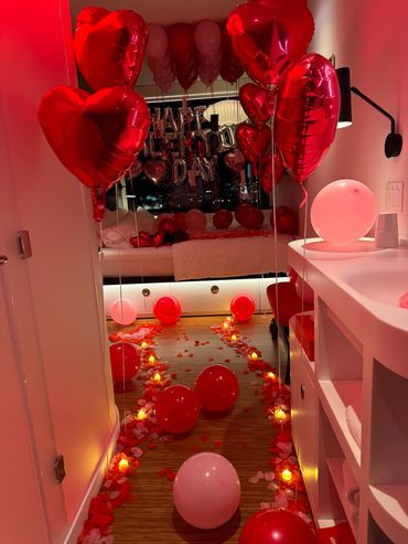 candles and rose pedals leading to a bed in a romantically decorated hotel room in boston