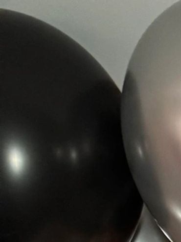 a hotel room romantically decorated for an anniversary in boston with balloons and champagne