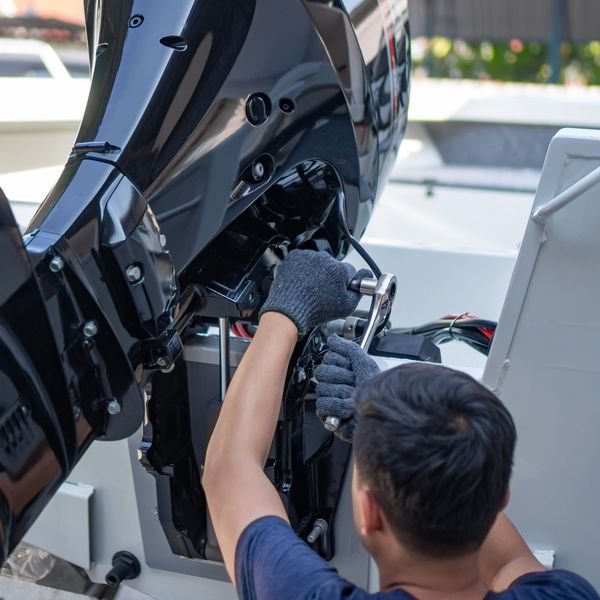 An engineer repairing a boat engine