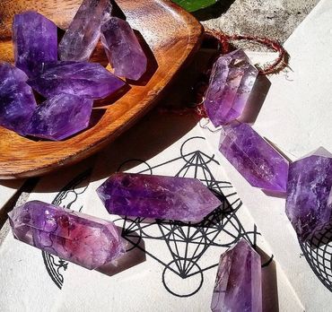 Amethyst crystals arranged on a mystical geometric design.