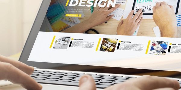 a web designer working on a responsive design website on a laptop