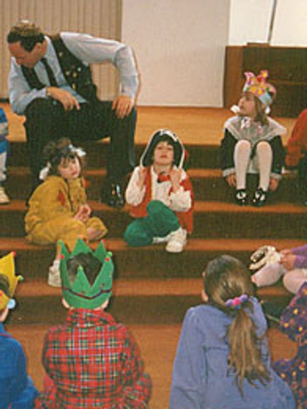 A preschool class enjoys Purim stories with Gerald Fierst, storyteller