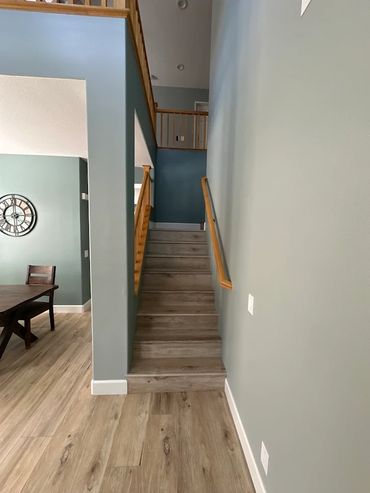 Freshly painted stairway and hallway with modern trim finish by professional house painters in OC