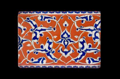 Iznik tile with blue palmettes on red ground