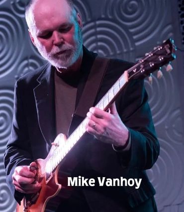 Mike Vanhoy playing electric guitar on stage with focused expression.