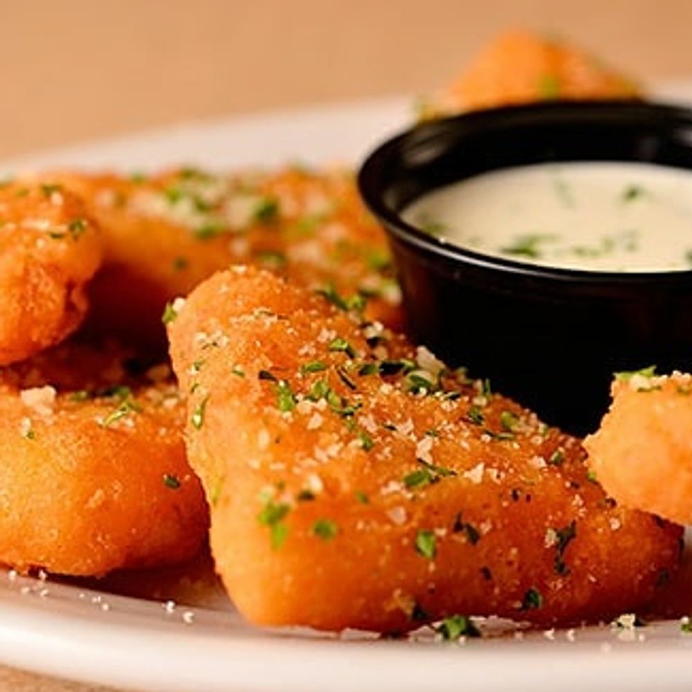 Macaroni and Cheese wedges coated with batter and deep fried.