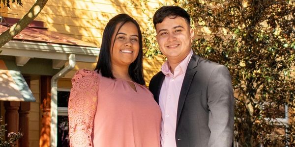 husband and wife smiling