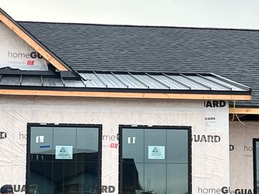New house under construction with modern window frames and roofing.