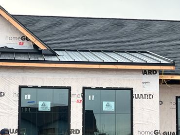 New house under construction with modern window frames and roofing.