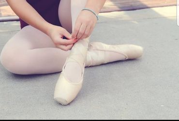 Ballet dancer is using recycled tights and leotard, allowing her to participate in dance class.