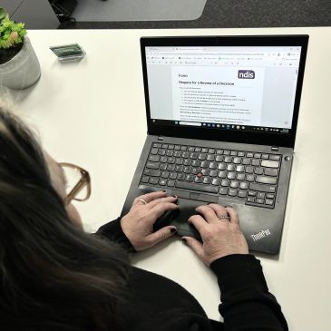 Person typing on a laptop at a desk.