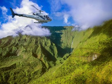 helicopter flying into green valley